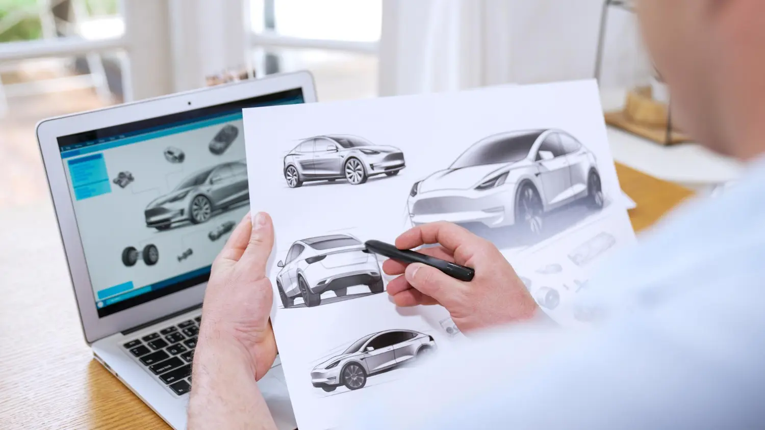 Designer working on car sketches